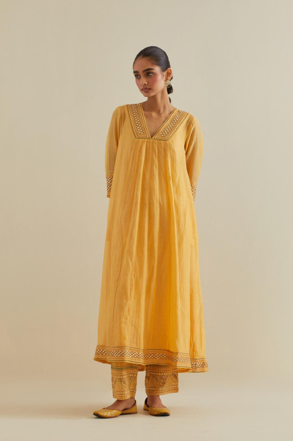 Yellow cotton chanderi kurta dress set with a V neck embroidered yoke and panels.