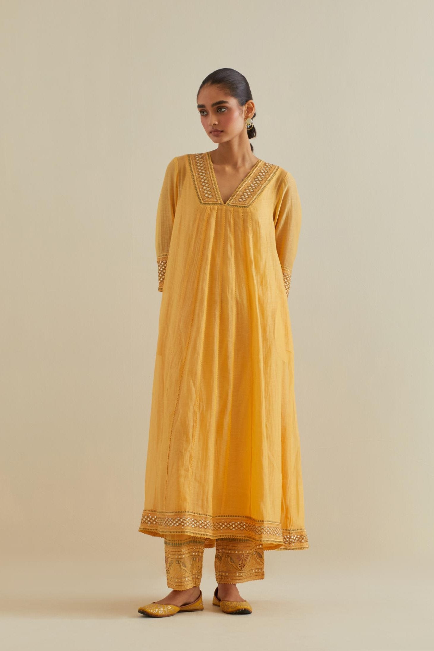 Yellow cotton chanderi kurta dress set with a V neck embroidered yoke and panels.