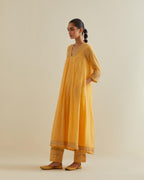 Yellow cotton chanderi kurta dress set with a V neck embroidered yoke and panels.