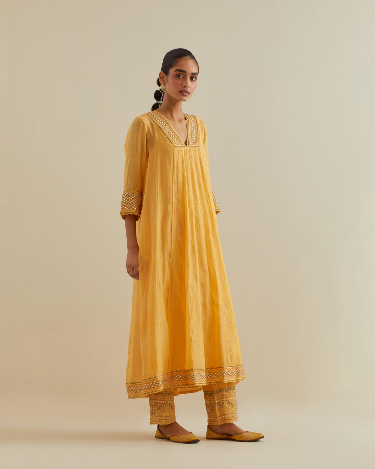Yellow cotton chanderi kurta dress set with a V neck embroidered yoke and panels.