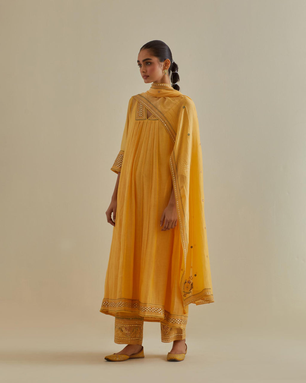 Yellow cotton chanderi kurta dress set with a V neck embroidered yoke and panels.