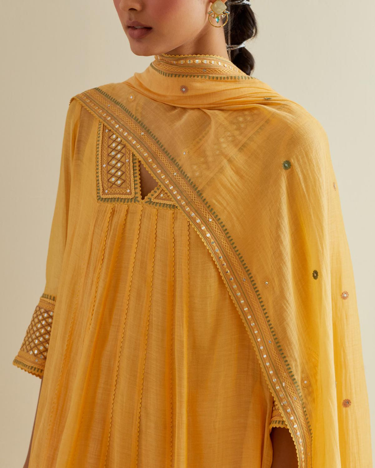 Yellow cotton chanderi kurta dress set with a V neck embroidered yoke and panels.