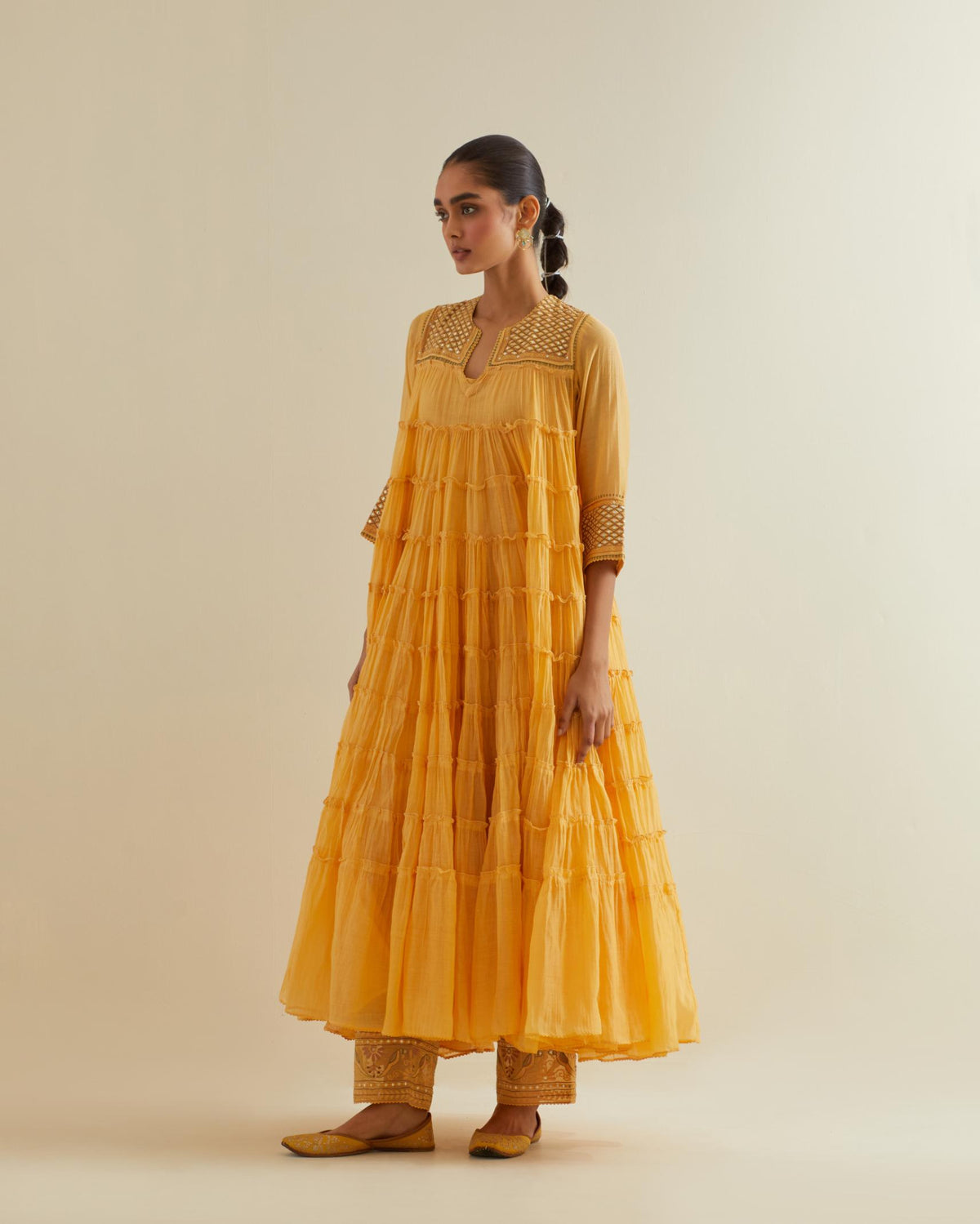 Yellow cotton chanderi multi-tiered kurta dress set with 3/4 sleeves, highlighted with mirror work.