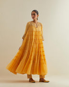 Yellow cotton chanderi multi-tiered kurta dress set with 3/4 sleeves, highlighted with mirror work.