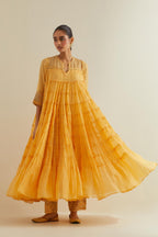 Yellow cotton chanderi multi-tiered kurta dress set with 3/4 sleeves, highlighted with mirror work.