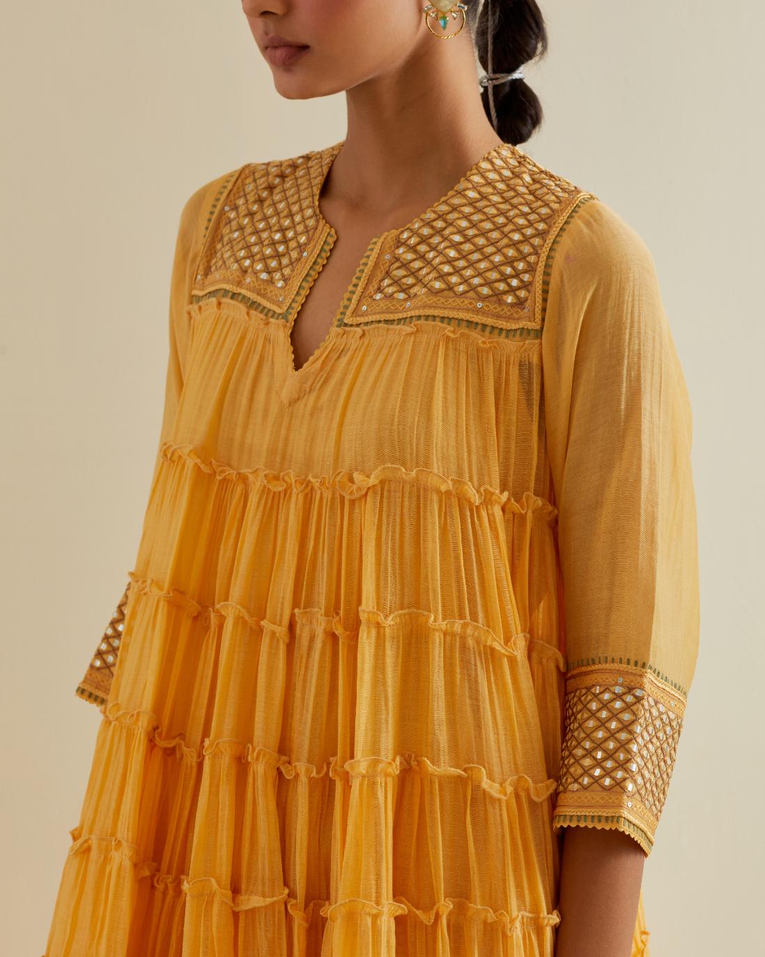 Yellow cotton chanderi multi-tiered kurta dress set with 3/4 sleeves, highlighted with mirror work.