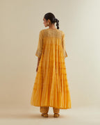 Yellow cotton chanderi multi-tiered kurta dress set with 3/4 sleeves, highlighted with mirror work.
