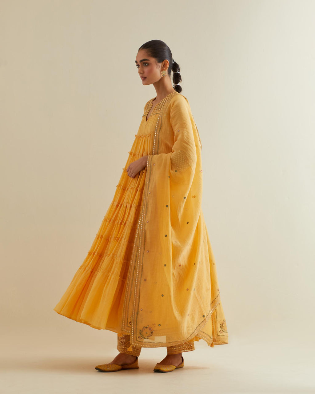 Yellow cotton chanderi multi-tiered kurta dress set with 3/4 sleeves, highlighted with mirror work.