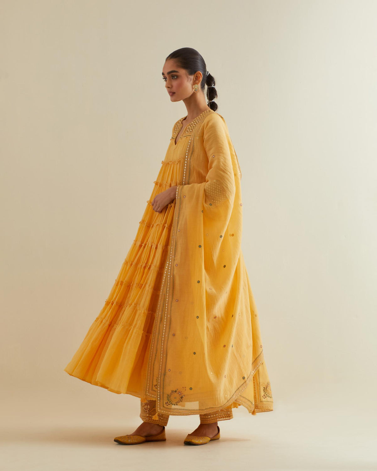 Yellow cotton chanderi multi-tiered kurta dress set with 3/4 sleeves, highlighted with mirror work.