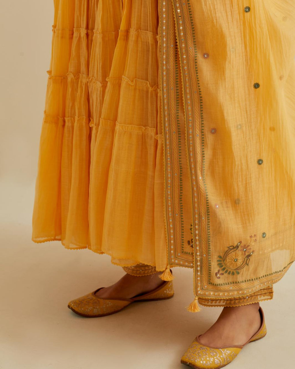 Yellow cotton chanderi multi-tiered kurta dress set with 3/4 sleeves, highlighted with mirror work.