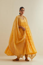 Yellow cotton chanderi multi-tiered kurta dress set with 3/4 sleeves, highlighted with mirror work.