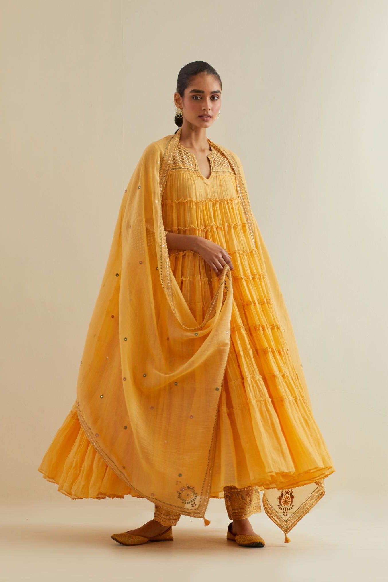 Yellow cotton chanderi multi-tiered kurta dress set with 3/4 sleeves, highlighted with mirror work.