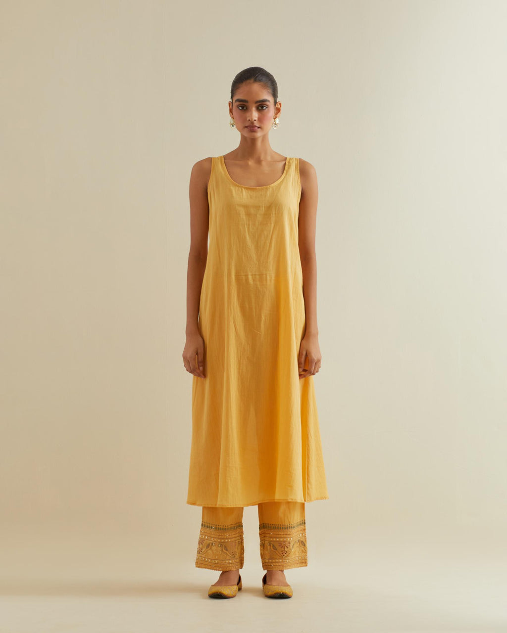 Yellow cotton chanderi multi-tiered kurta dress set with 3/4 sleeves, highlighted with mirror work.