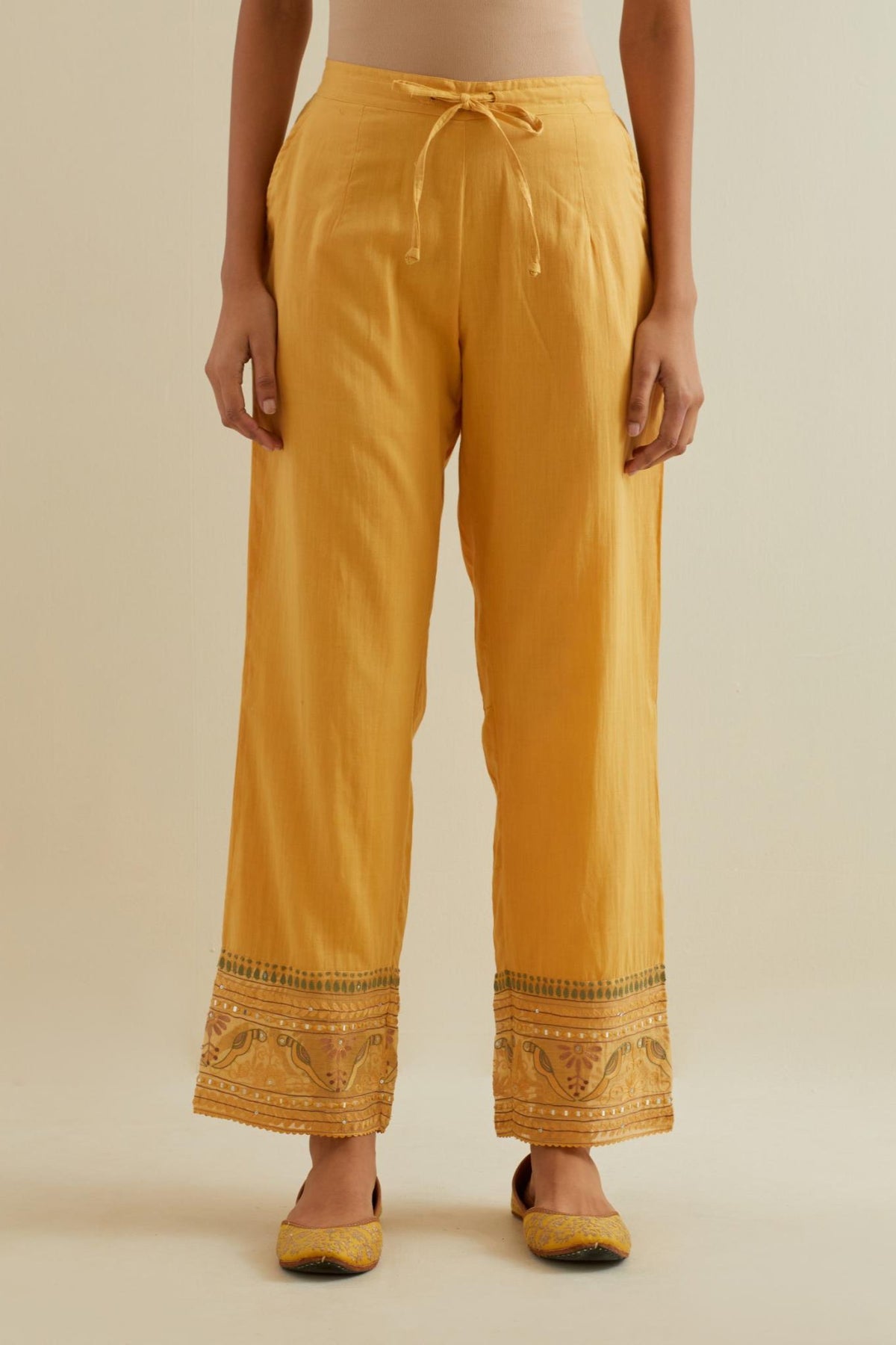 Yellow straight pants with all over multi color embroidery detailed with sequins.