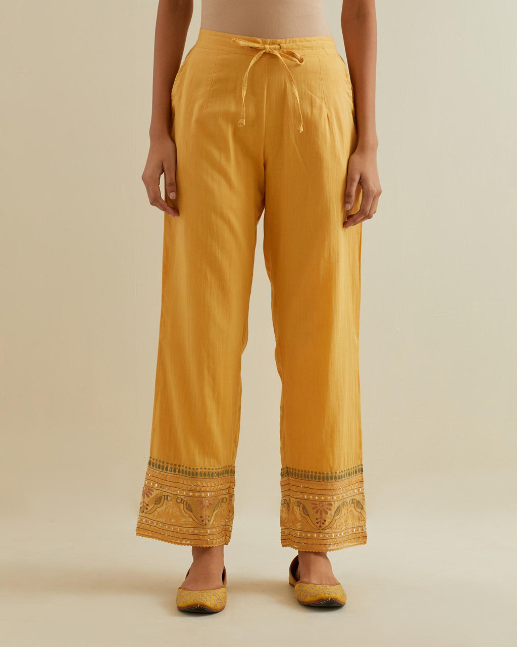 Yellow straight pants with all over multi color embroidery detailed with sequins.