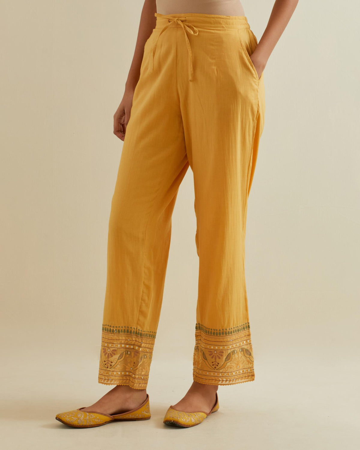 Yellow straight pants with all over multi color embroidery detailed with sequins.