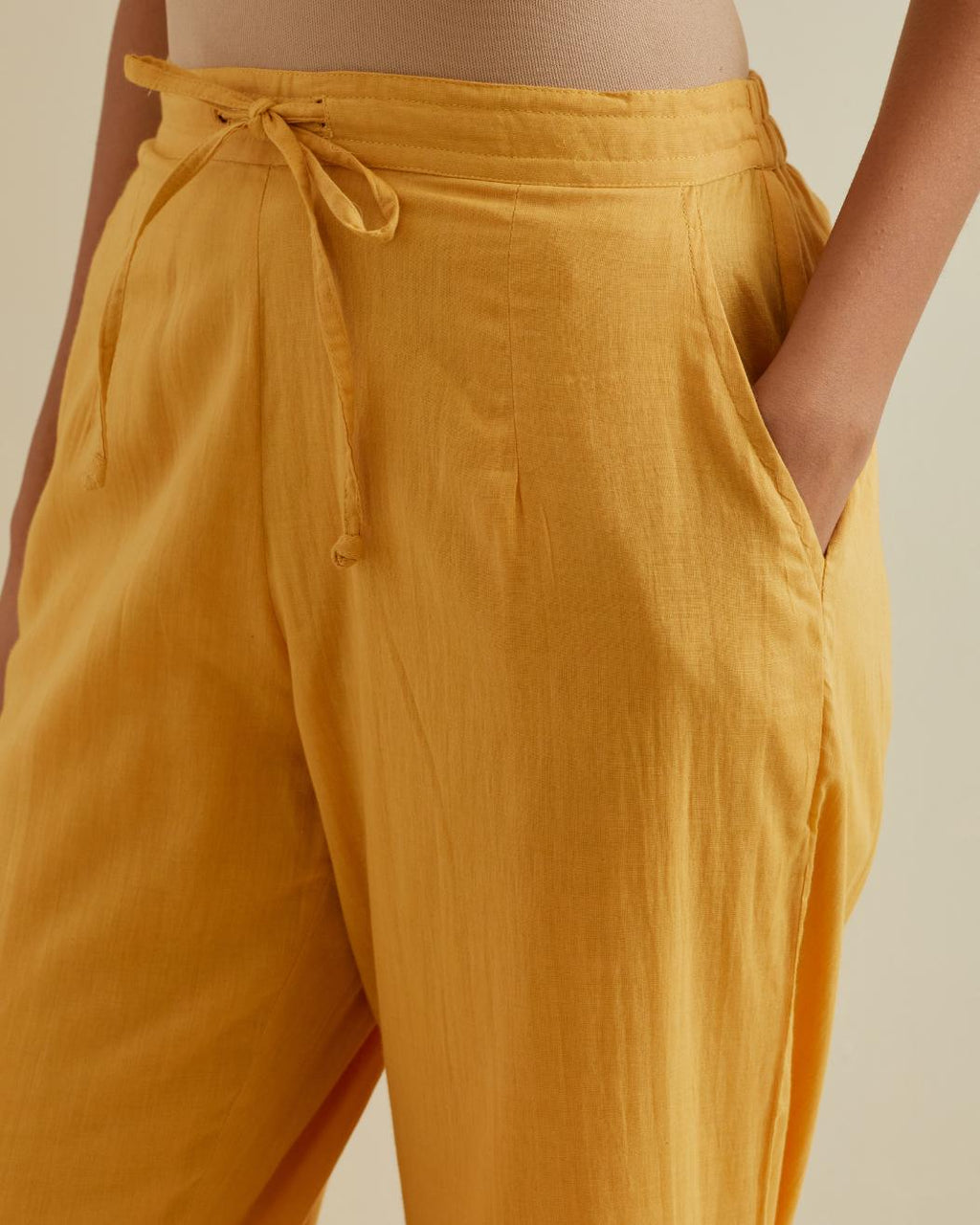 Yellow straight pants with all over multi color embroidery detailed with sequins.