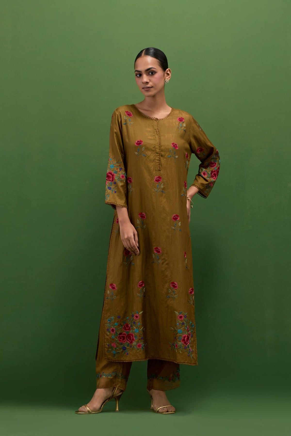Golden olive silk straight kurta set with all-over roses embroidered in thread and scalloped organza detail at the edges.