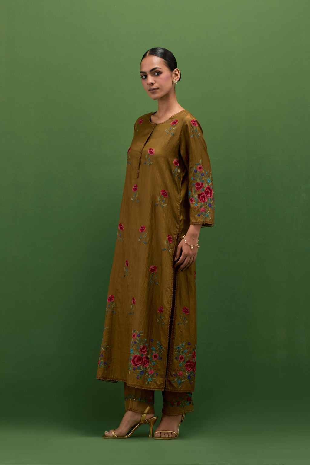 Golden olive silk straight kurta set with all-over roses embroidered in thread and scalloped organza detail at the edges.