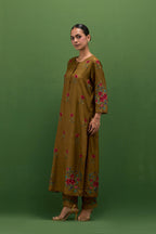 Golden olive silk straight kurta set with all-over roses embroidered in thread and scalloped organza detail at the edges.
