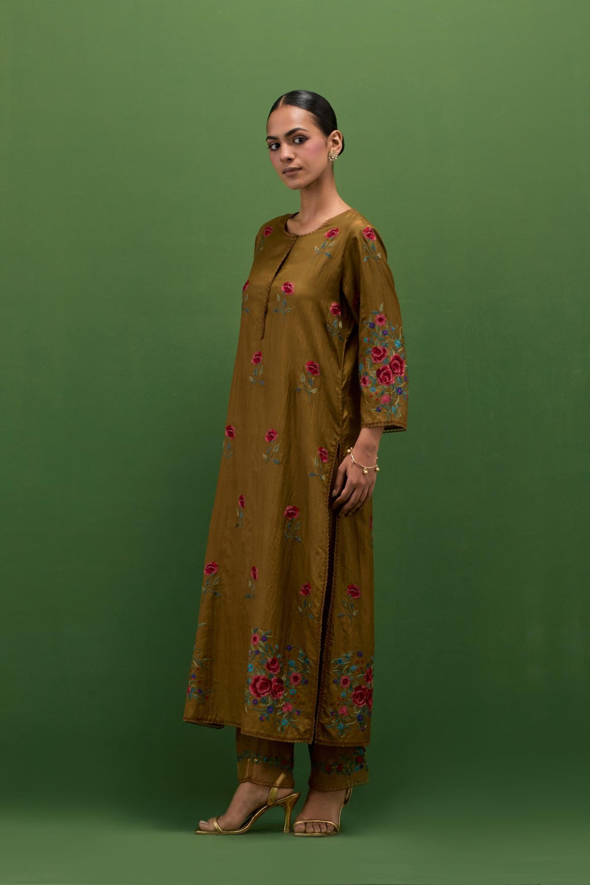 Golden olive silk straight kurta set with all-over roses embroidered in thread and scalloped organza detail at the edges.
