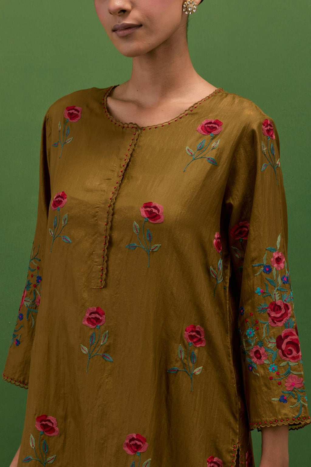 Golden olive silk straight kurta set with all-over roses embroidered in thread and scalloped organza detail at the edges.