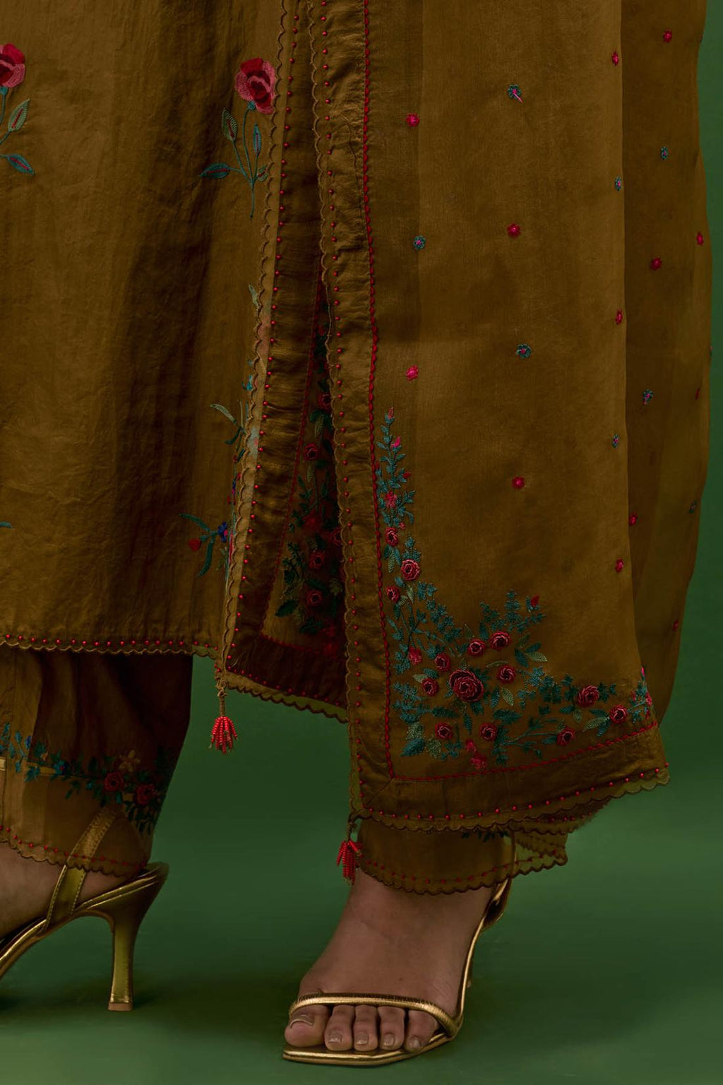 Golden olive silk straight kurta set with all-over roses embroidered in thread and scalloped organza detail at the edges.
