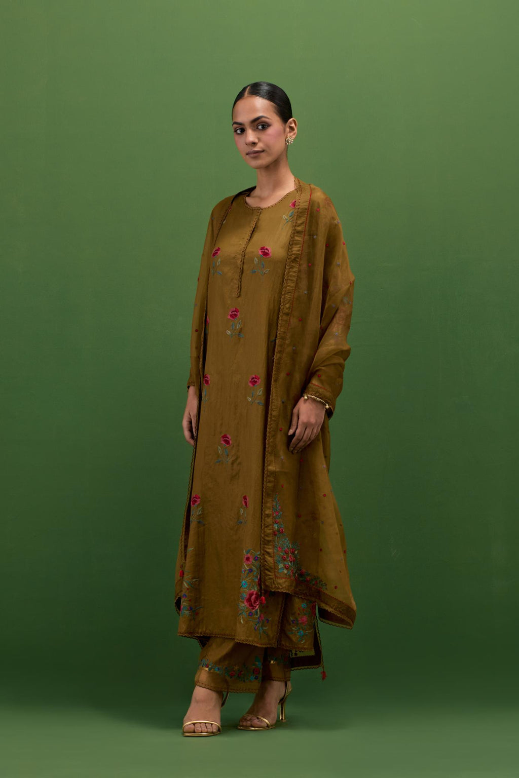 Golden olive silk straight kurta set with all-over roses embroidered in thread and scalloped organza detail at the edges.