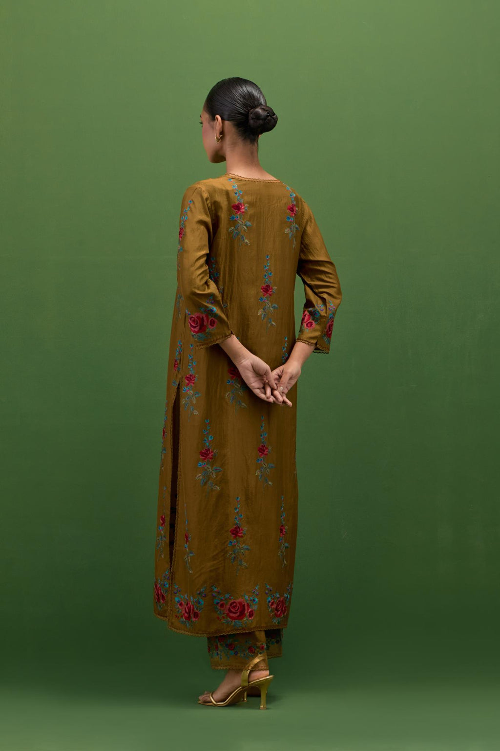 Golden olive silk straight kurta set with all-over rose embroidery and scalloped organza detail at the edges.