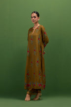 Golden olive silk straight kurta set with all-over rose embroidery and scalloped organza detail at the edges.