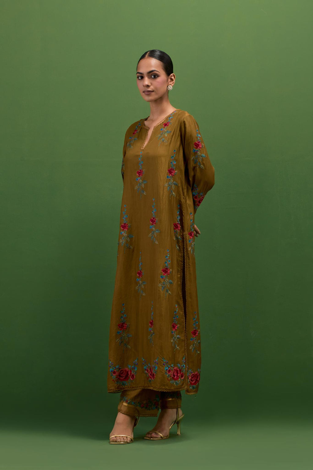 Golden olive silk straight kurta set with all-over rose embroidery and scalloped organza detail at the edges.