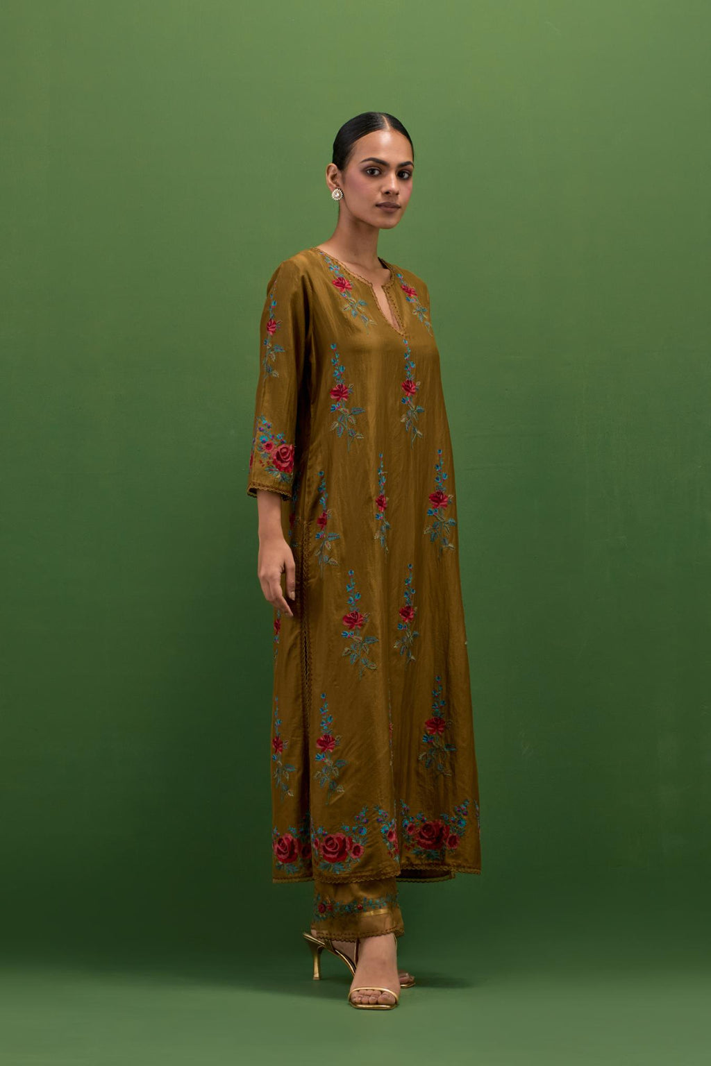 Golden olive silk straight kurta set with all-over rose embroidery and scalloped organza detail at the edges.