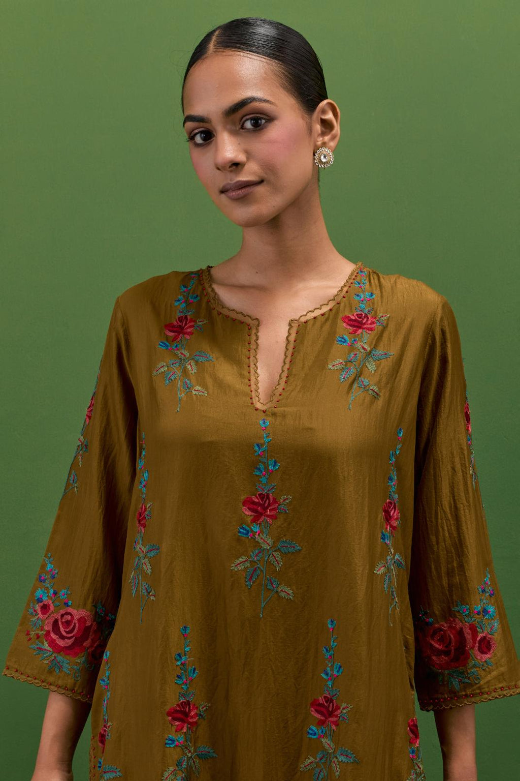 Golden olive silk straight kurta set with all-over rose embroidery and scalloped organza detail at the edges.