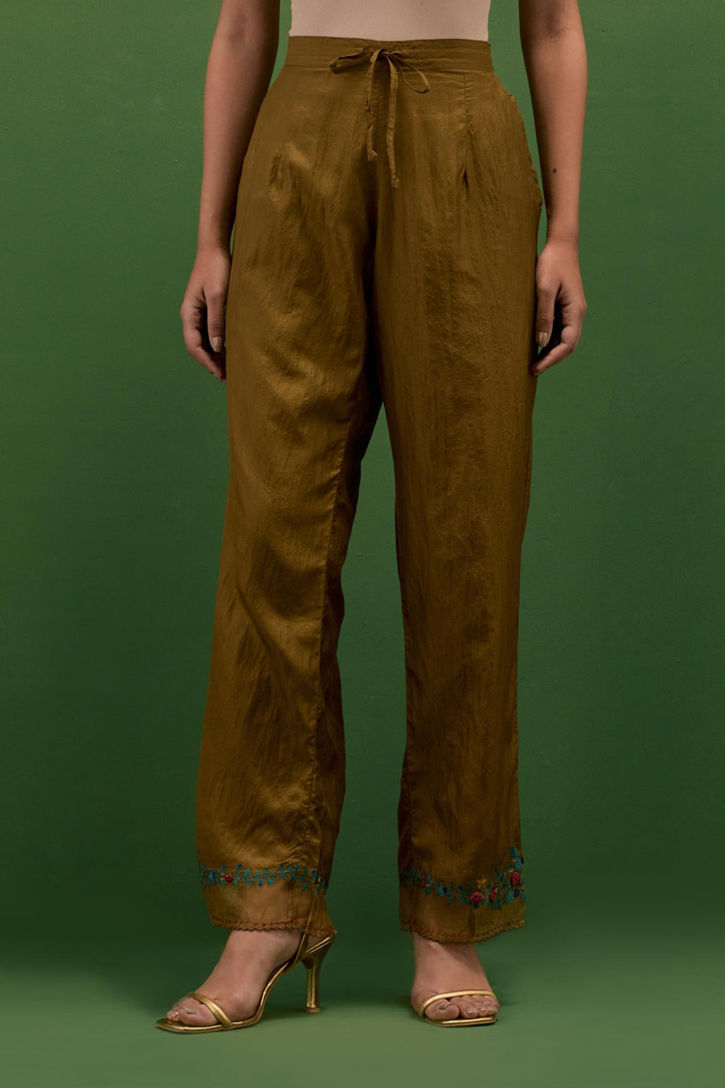 Golden olive silk straight pants with a broad organza scalloped hem, hightlighted with hand-embroidred rose flower bunches and beads.