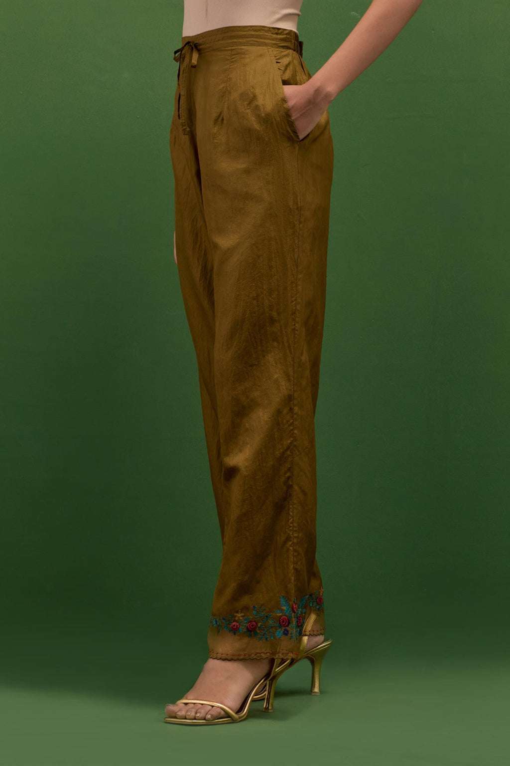 Golden olive silk straight pants with a broad organza scalloped hem, hightlighted with hand-embroidred rose flower bunches and beads.