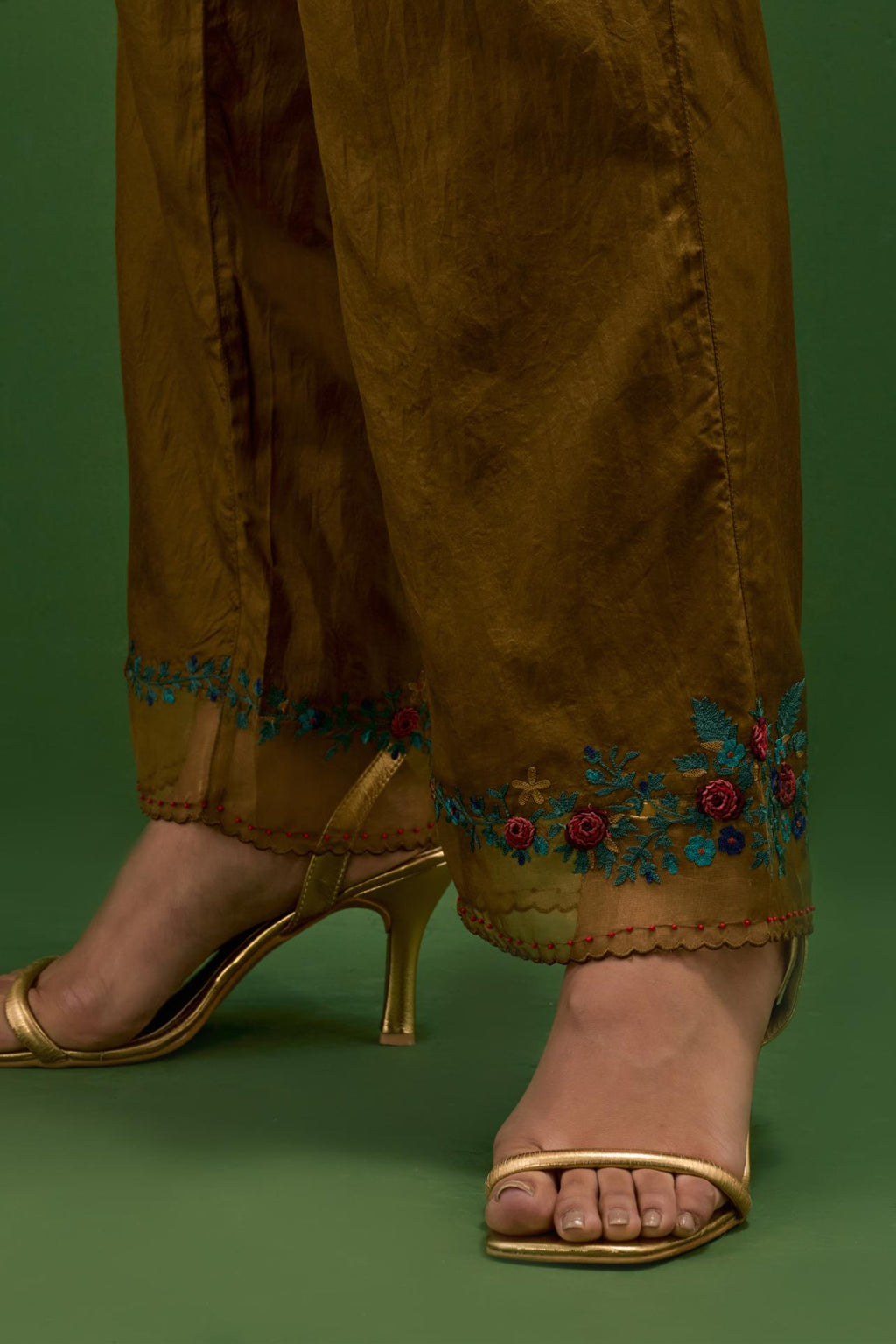 Golden olive silk straight pants with a broad organza scalloped hem, hightlighted with hand-embroidred rose flower bunches and beads.