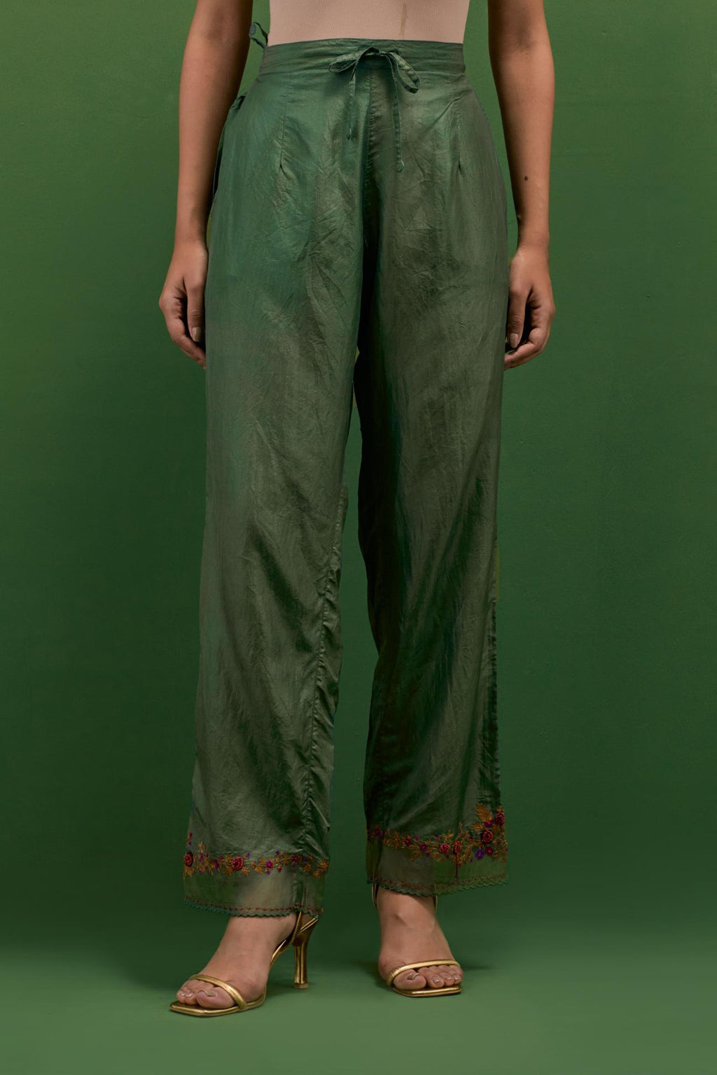 Brunswick green silk straight pants with a broad organza scalloped hem, hightlighted with hand-embroidred rose flower bunches and beads.