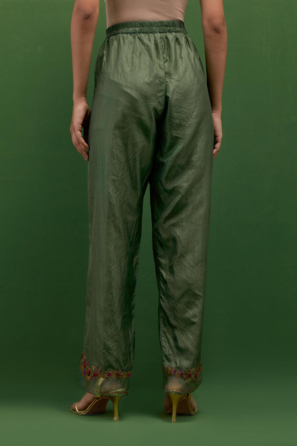 Brunswick green silk straight pants with a broad organza scalloped hem, hightlighted with hand-embroidred rose flower bunches and beads.