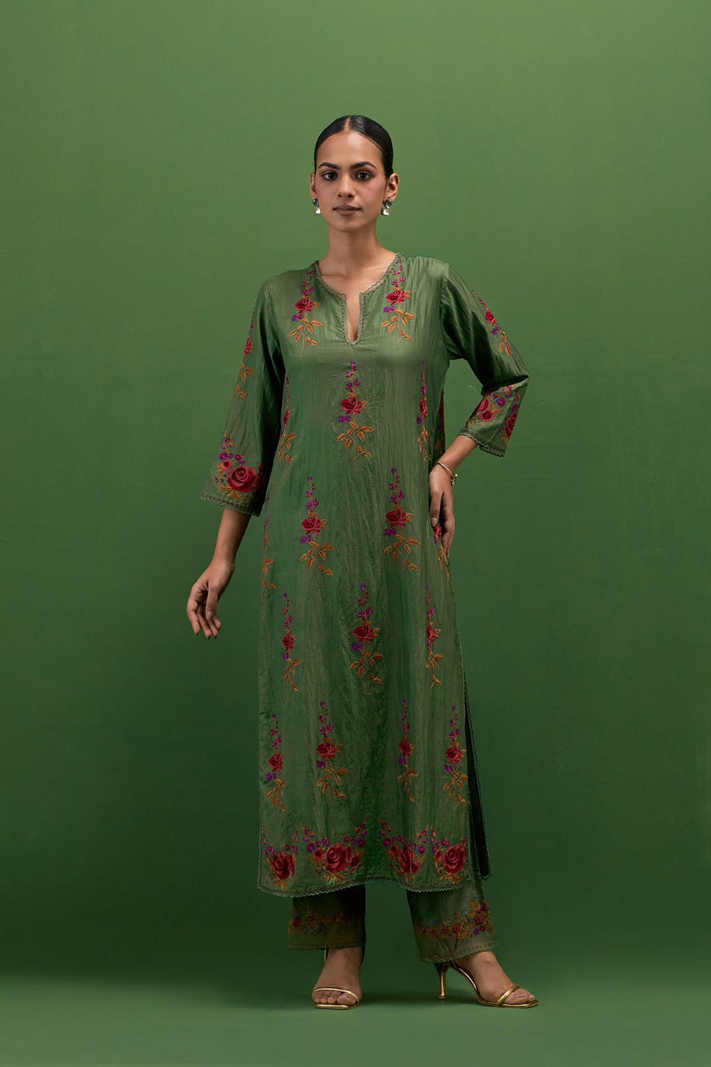 Brunswick green silk straight kurta set with all-over rose embroidery and scalloped organza detail at the edges.