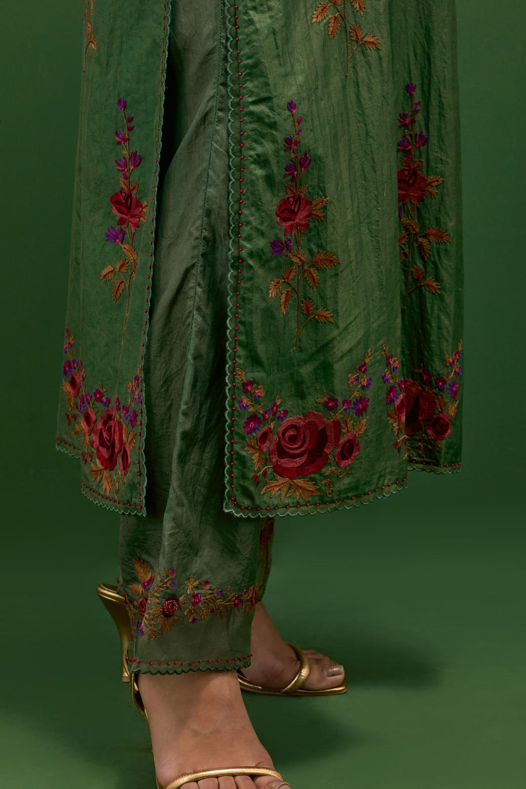 Brunswick green silk straight kurta set with all-over rose embroidery and scalloped organza detail at the edges.