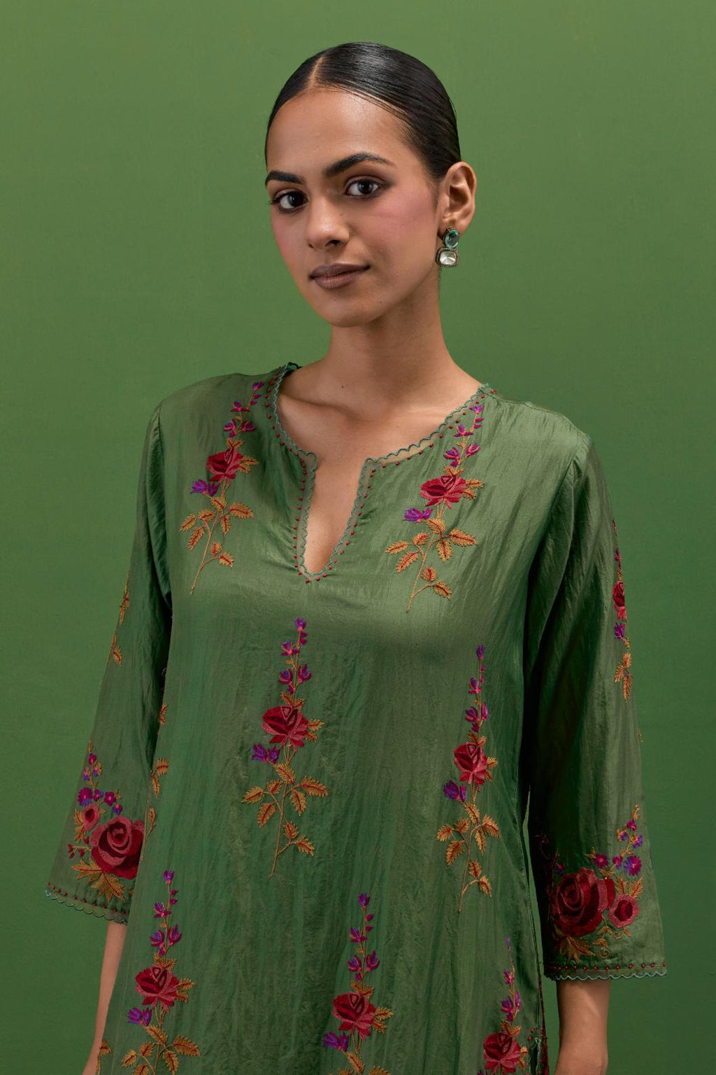 Brunswick green silk straight kurta set with all-over rose embroidery and scalloped organza detail at the edges.