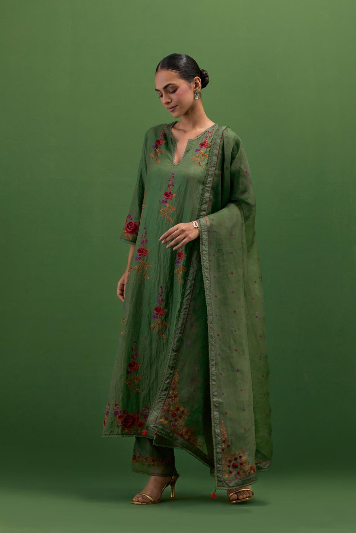 Brunswick green silk straight kurta set with all-over rose embroidery and scalloped organza detail at the edges.
