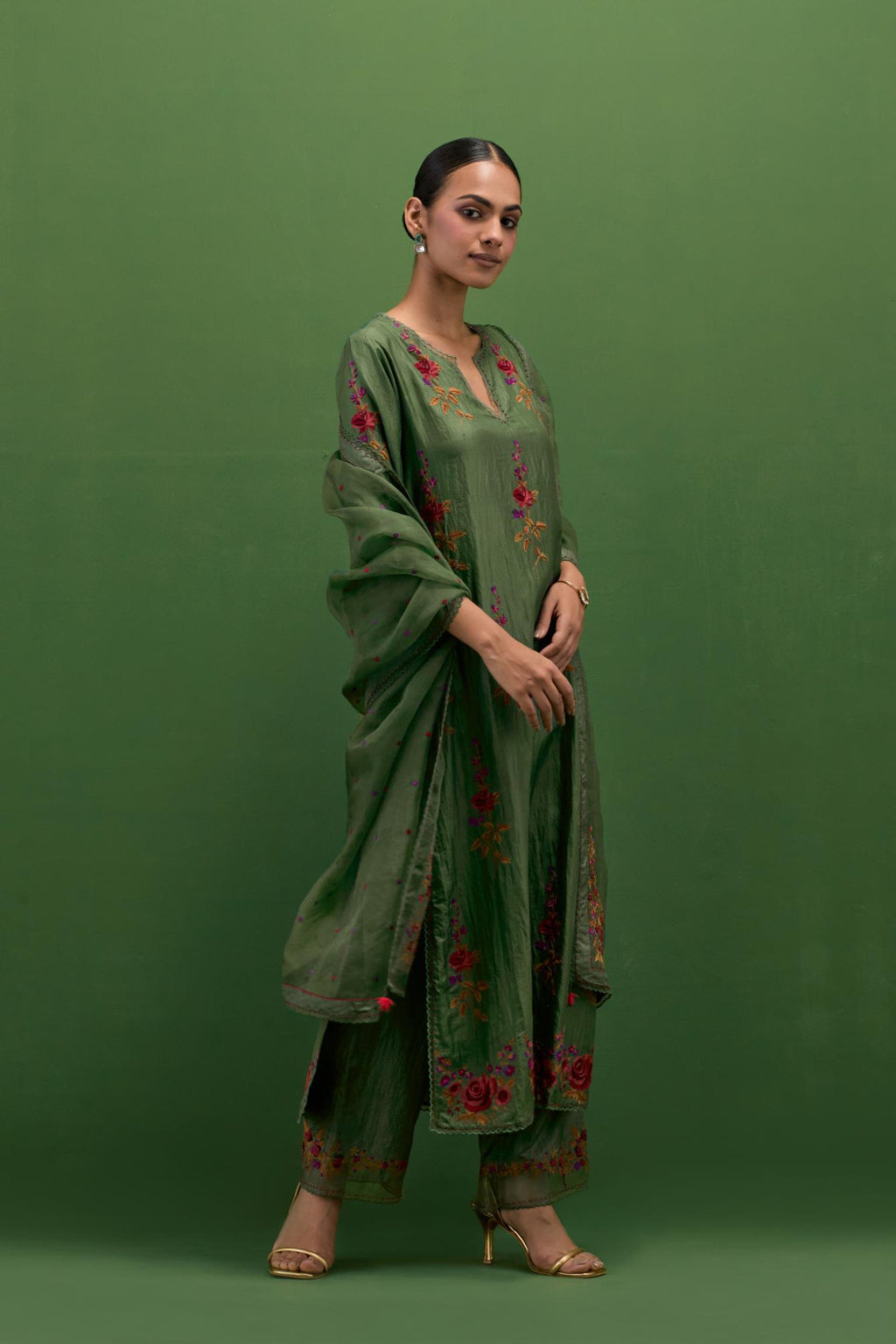 Brunswick green silk straight kurta set with all-over rose embroidery and scalloped organza detail at the edges.