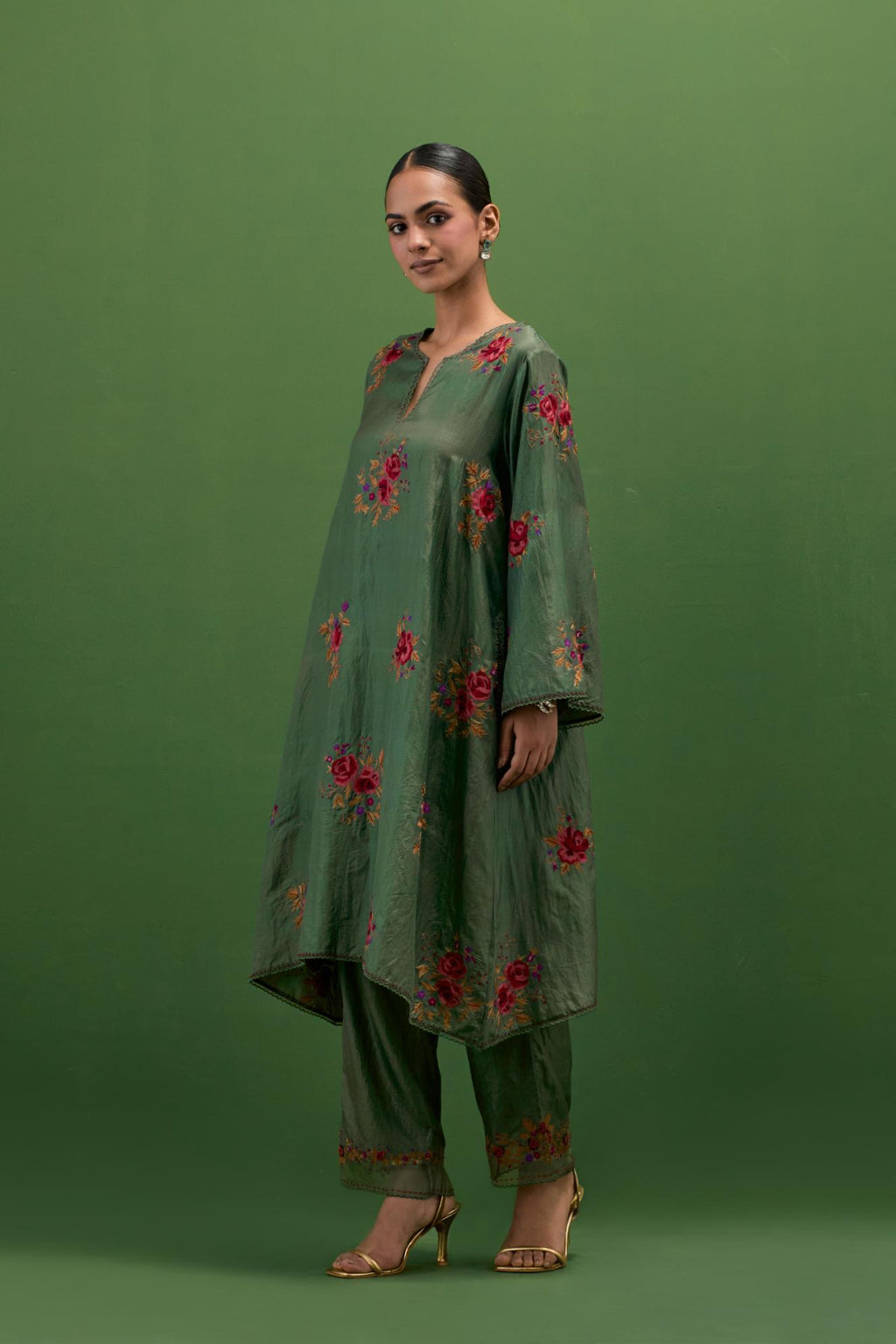 Brunswick green silk A-line short kurta set, with thread embroidery roses all over.