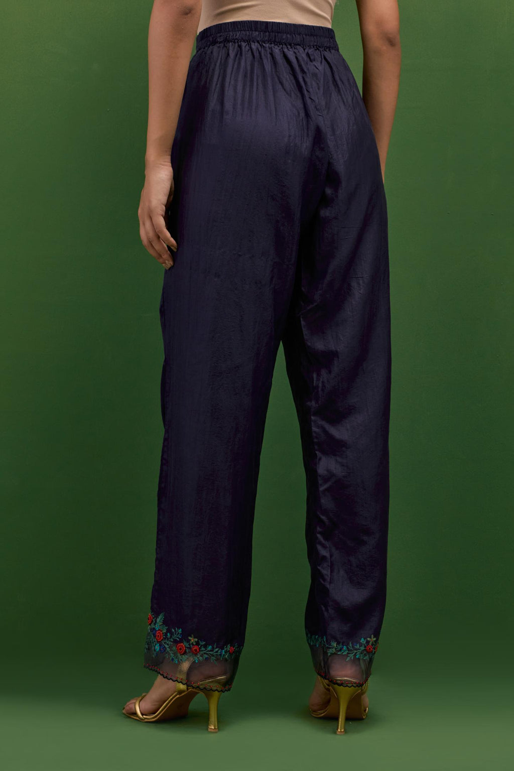 Midnight blue silk straight pants with a broad organza scalloped hem, hightlighted with hand-embroidred rose flower bunches and beads.