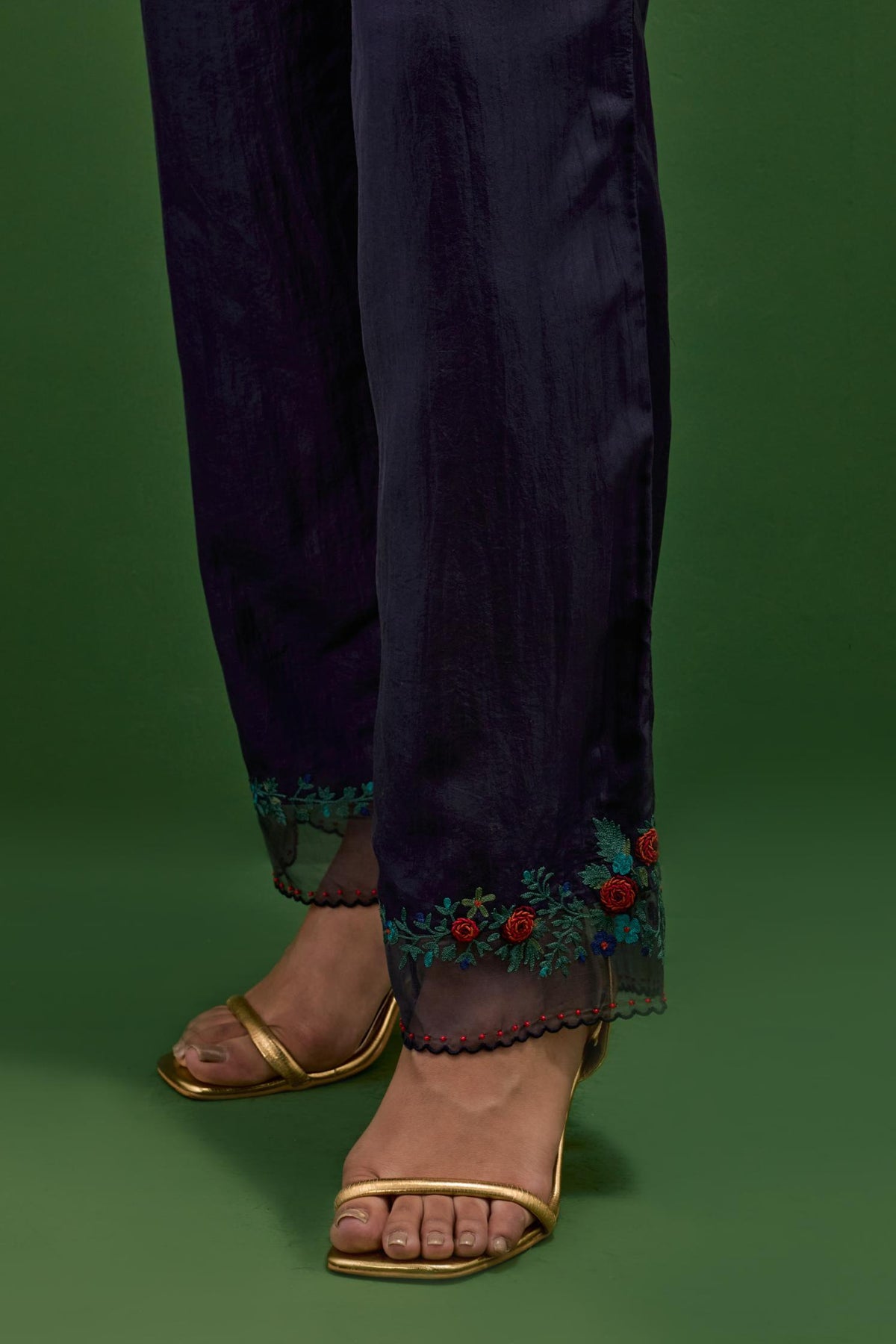 Midnight blue silk straight pants with a broad organza scalloped hem, hightlighted with hand-embroidred rose flower bunches and beads.