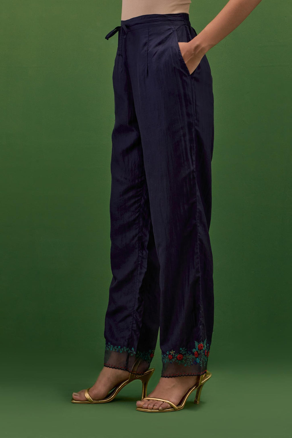 Midnight blue silk straight pants with a broad organza scalloped hem, hightlighted with hand-embroidred rose flower bunches and beads.