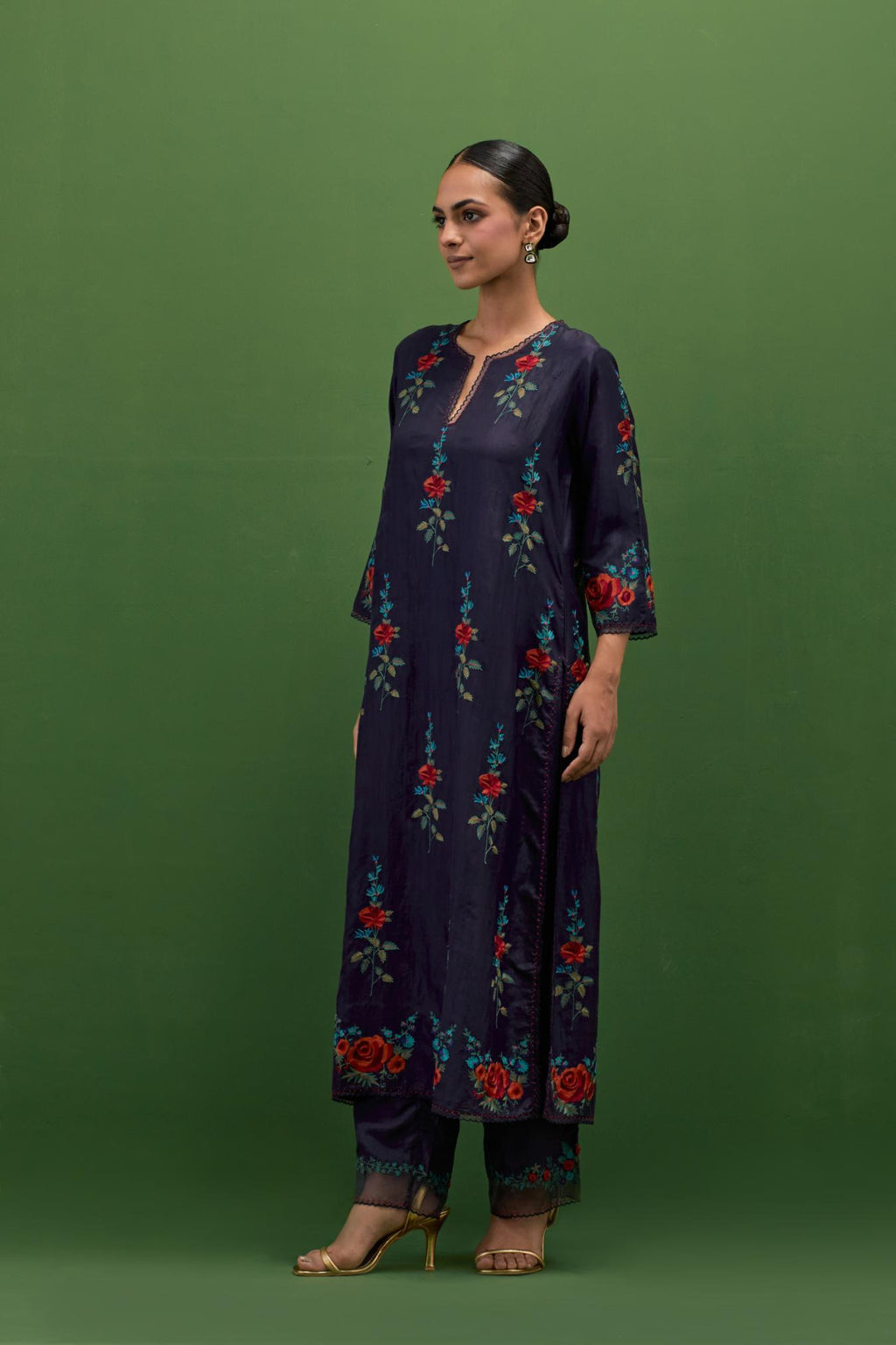 Midnight blue silk straight kurta set with all-over rose embroidery and scalloped organza detail at the edges.