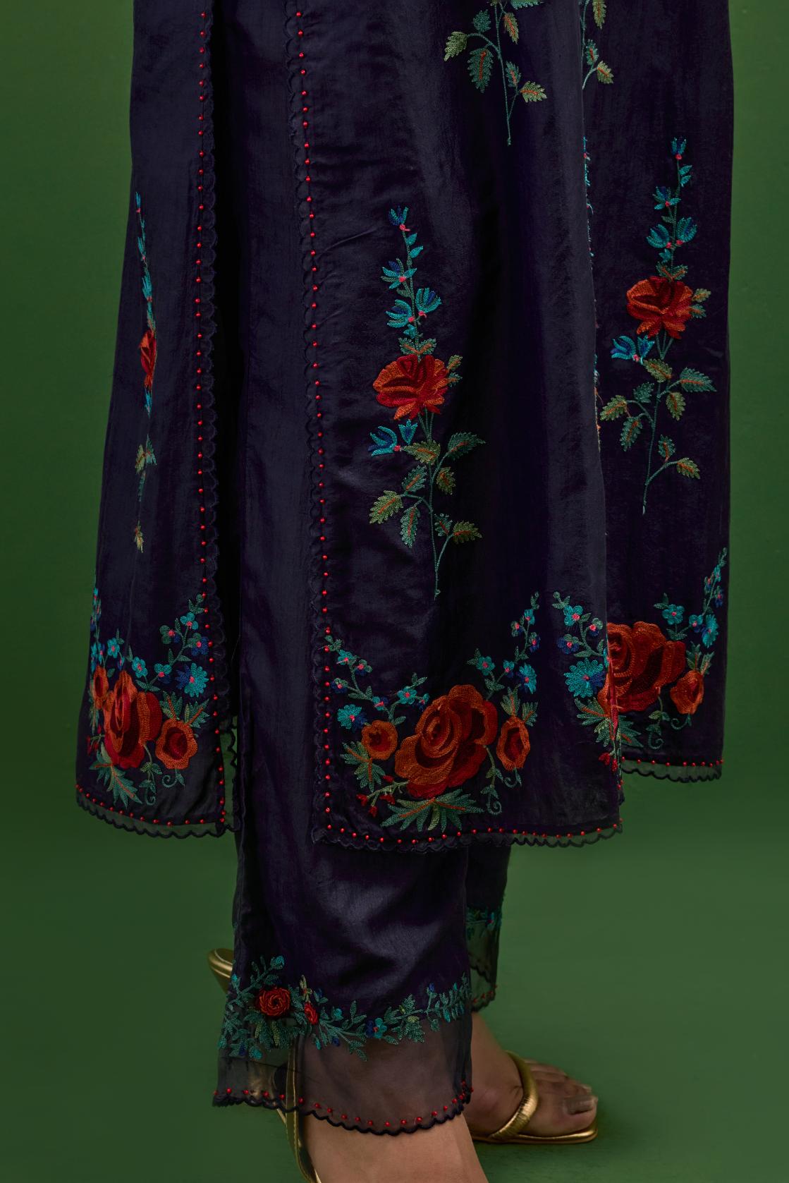 Midnight blue silk straight kurta set with all-over rose embroidery and scalloped organza detail at the edges.