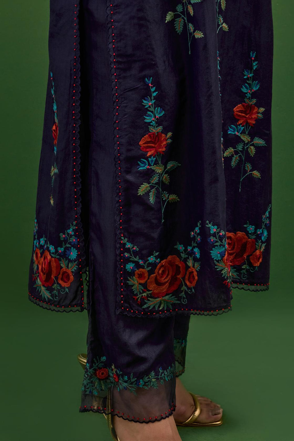 Midnight blue silk straight kurta set with all-over rose embroidery and scalloped organza detail at the edges.